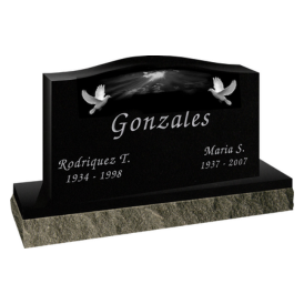 Black headstone with curved top and engraving of sky and birds